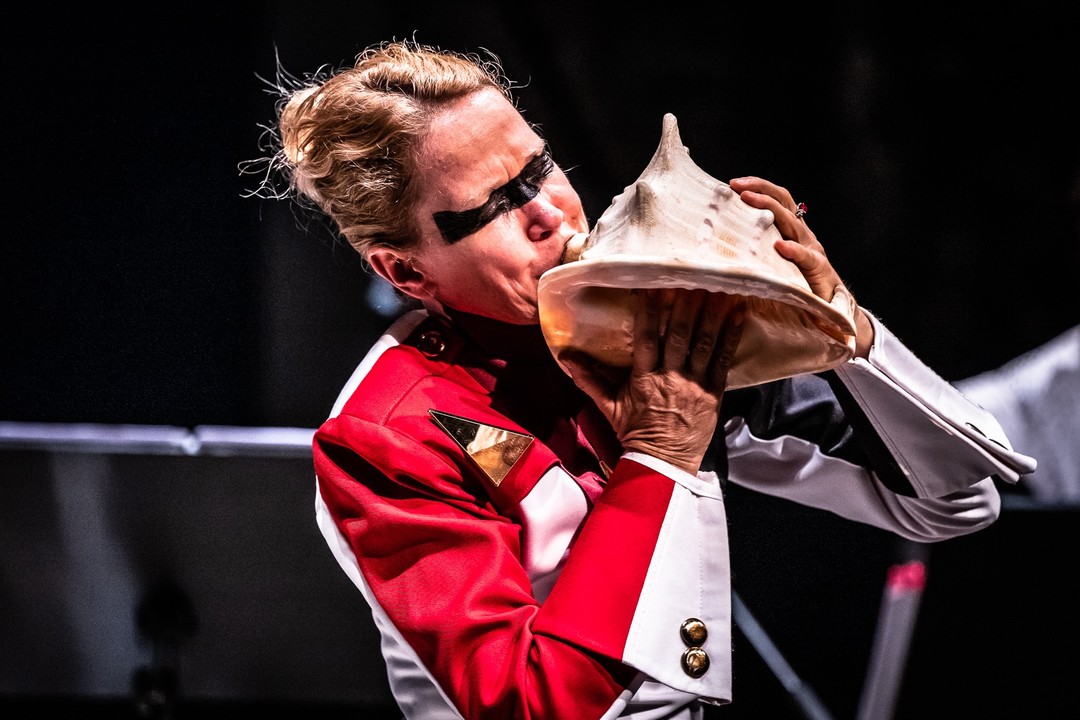 Christine Chapman playing a conch